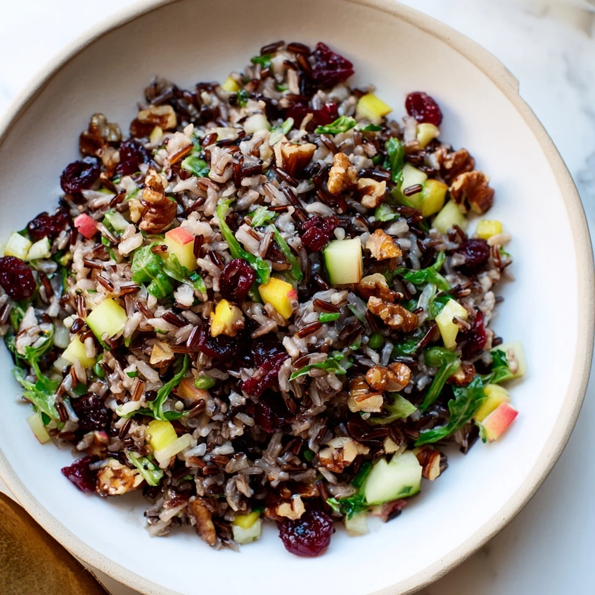 Light Forest-Inspired Wild Rice and Cranberry Salad, a vibrant bowl of fresh greens with a sweet and savory, zesty dressing.