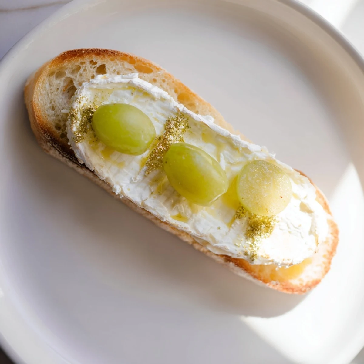 A close-up of sparkling Champagne toast appetizers with golden grapes, ready to celebrate.