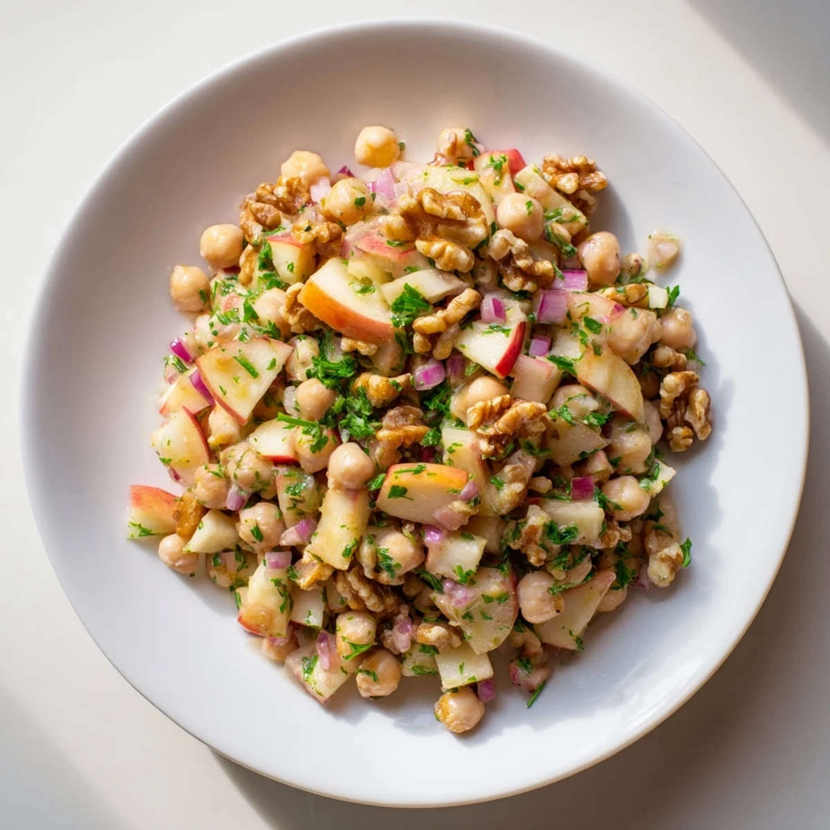 Fall Harvest Apple and Chickpea Salad: a colorful bowl with crisp apples, chickpeas, walnuts, ready to eat.