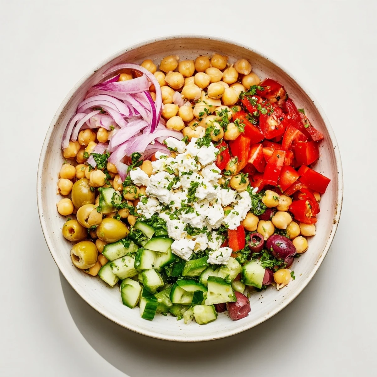 Mediterranean Chickpea and Feta Bowl, a colorful dish with vibrant tomatoes, olives, and creamy feta.