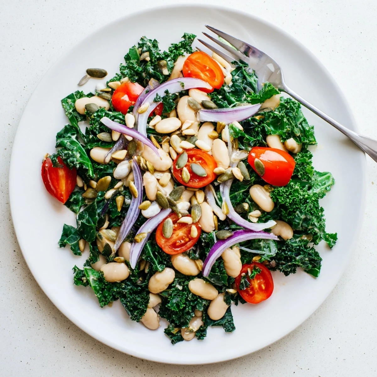 Hearty White Bean and Kale Salad served in a rustic bowl, topped with crunchy sunflower seeds and optional crumbled feta for extra flavor.