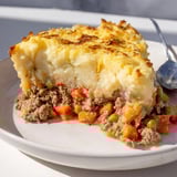 Hearty Warm Rustic Shepherds Pie, a close-up of seasoned lamb topped with creamy potatoes.