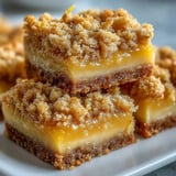 Close-up of Homemade Lemon Crumb Bars showcasing the tender, gooey lemon layer and buttery crumble texture.