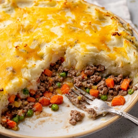 Golden brown Warm Rustic Shepherds Pie with bubbling cheesy potato topping.