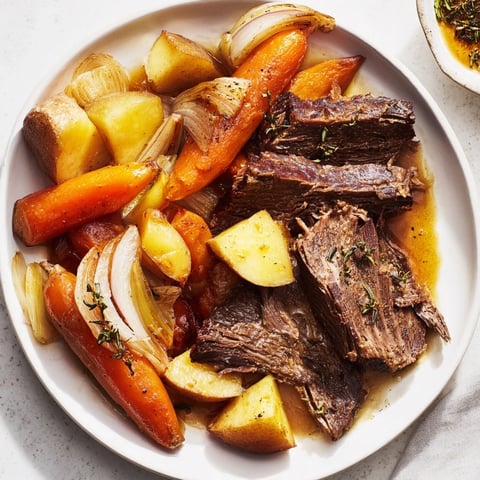 Tender Everyday Family Favorite Pot Roast, loaded with vibrant root vegetables in a rich gravy.