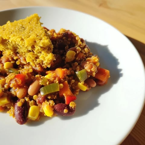 Golden cornbread tops the savory Rustic Wheat-Warm Chili, a hearty vegetarian meal option.
