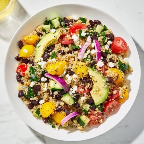 Bright, colorful Poppy-Bright Quinoa and Black Bean Salad, a satisfying vegetarian dish, with fresh vegetables.