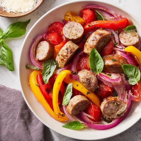 Sizzling Basil-Boosted Sausage and Pepper Skillet Supper, bursting with tomatoes, ready to serve over rice.