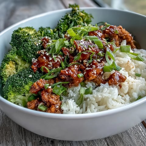 Sweet and spicy turkey broccoli bowls with tender turkey in a fiery glaze and fluffy brown rice. Steamed broccoli florets garnished with green onion and sesame seeds. A quick, easy dinner. 
