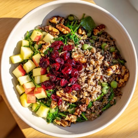 Enjoy this colorful Light Forest-Inspired Wild Rice and Cranberry Salad, overflowing with tender wild rice and tart cranberries.