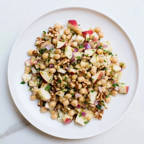 Fresh Fall Harvest Apple and Chickpea Salad, showcasing a sweet and tangy honey-mustard dressing.