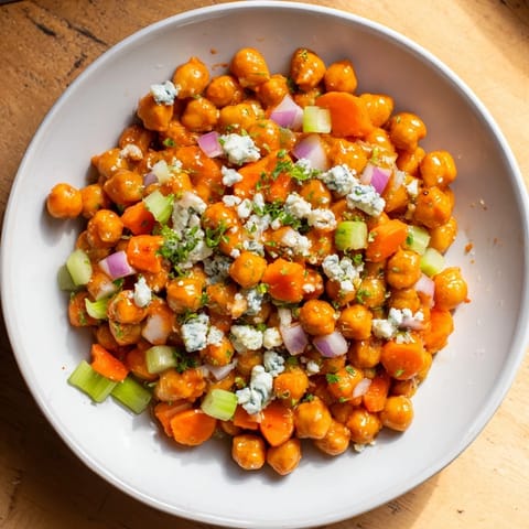 Close-up of the delicious Buffalo Chicken Bean Salad, showing colorful veggies and tangy buffalo sauce.