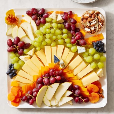 Sophisticated Art Deco Arch Cheese Platter with brie, blue cheese, and fresh grapes beautifully arranged.