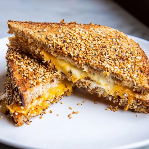 Crispy sourdough overflowing with melted cheese and delicious Everything Bagel Grilled Cheese seasoning.