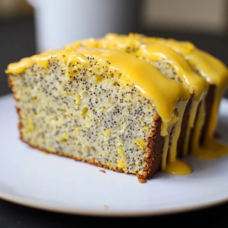 This sweet Glazed Lemon Poppy Seed Cake shows a close-up of the drizzled lemon icing.