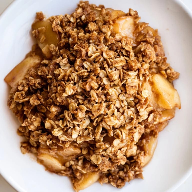 A close-up of a warm Soft Crumb Apple Crisp with a perfect crumb topping, ready to eat.