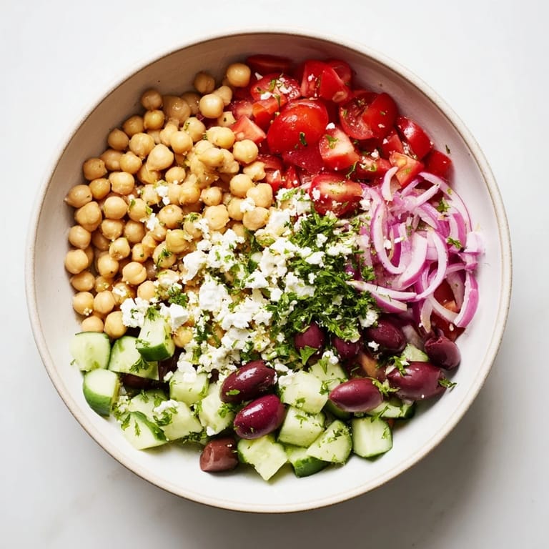 Freshly assembled Mediterranean Chickpea and Feta Bowl, a flavorful vegan meal with crisp veggies.