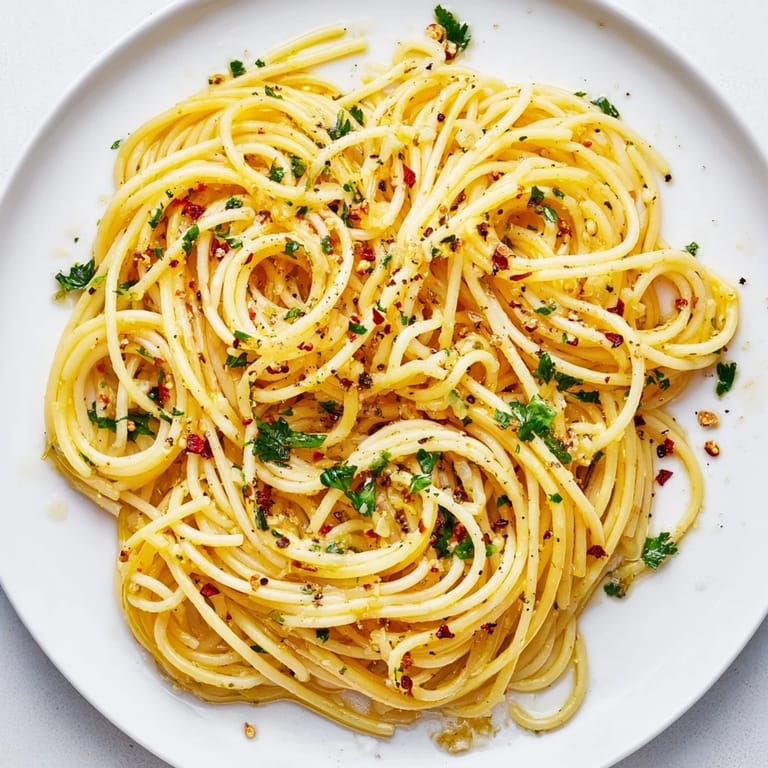 Enjoy a quick, easy Italian meal: flavorful Aglio e Olio pasta with Parmesan cheese.