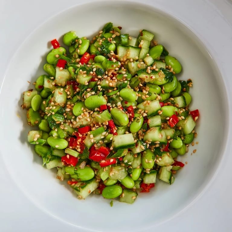 A bowl of delicious edamame salad: a vegan delight with sesame seeds sprinkled on top.