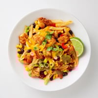 Golden, crispy chicken pieces top a cheesy pan of Crispy Chicken Burrito Pasta with melted cheddar and Monterey Jack.